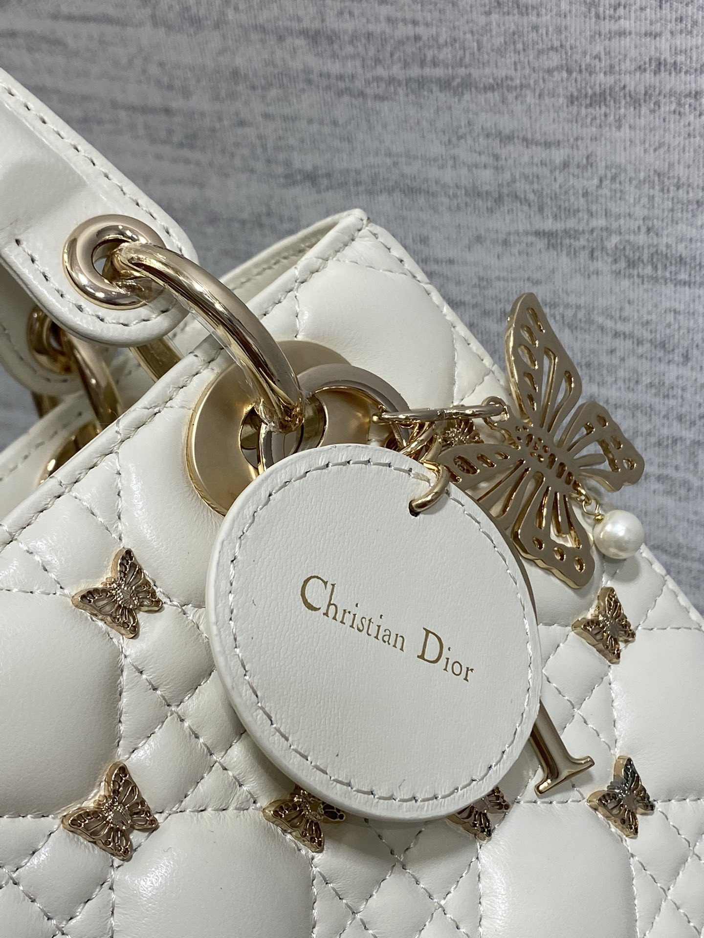 small lady D*or white with butterfly studs